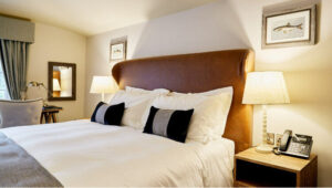 Elegant guest room at The Wellington Arms in Hampshire with plush bedding and warm lighting