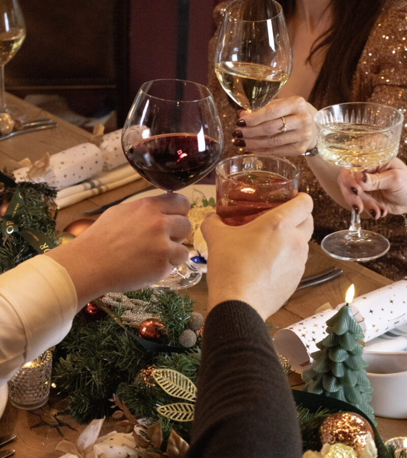 6 img 6558 Festive dining moment with friends clinking glasses at The Wellington Arms Basingstoke Road, Stratfield Turgis, Hampshire • RG27 0AS.